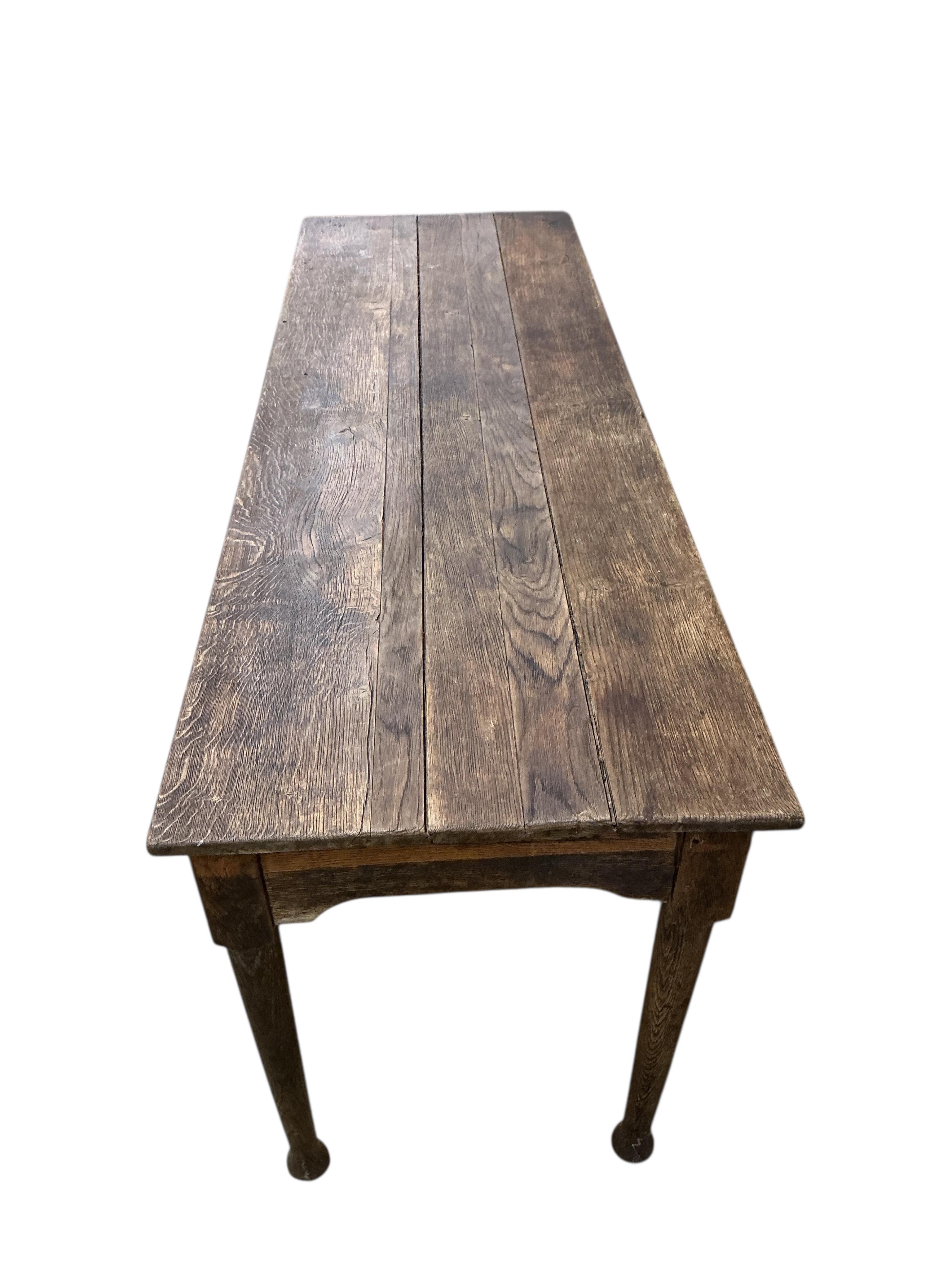 A 19th century rectangular oak plank topped dining table, width 183cm, depth 60cm, height 73cm